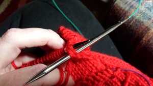 Purling edge stitch of the body together with last pocket stitch.